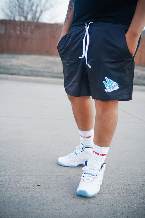 black and blue nylon neighborhood supplier logo streetwear shorts and crew socks