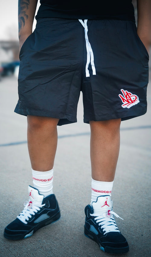 black and red nylon neighborhood supplier logo streetwear shorts and crew socks 