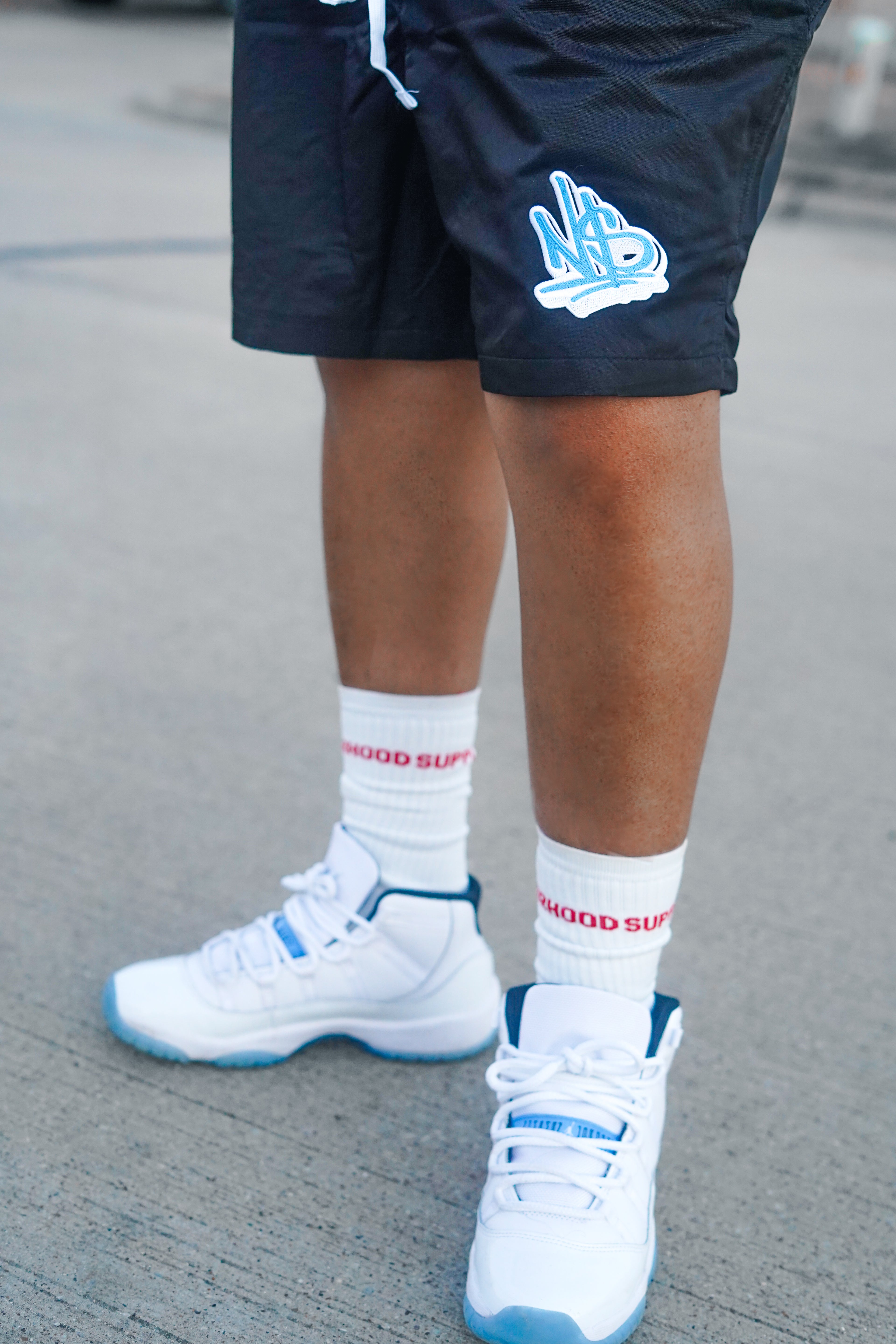 black and blue nylon neighborhood supplier logo streetwear shorts and crew socks